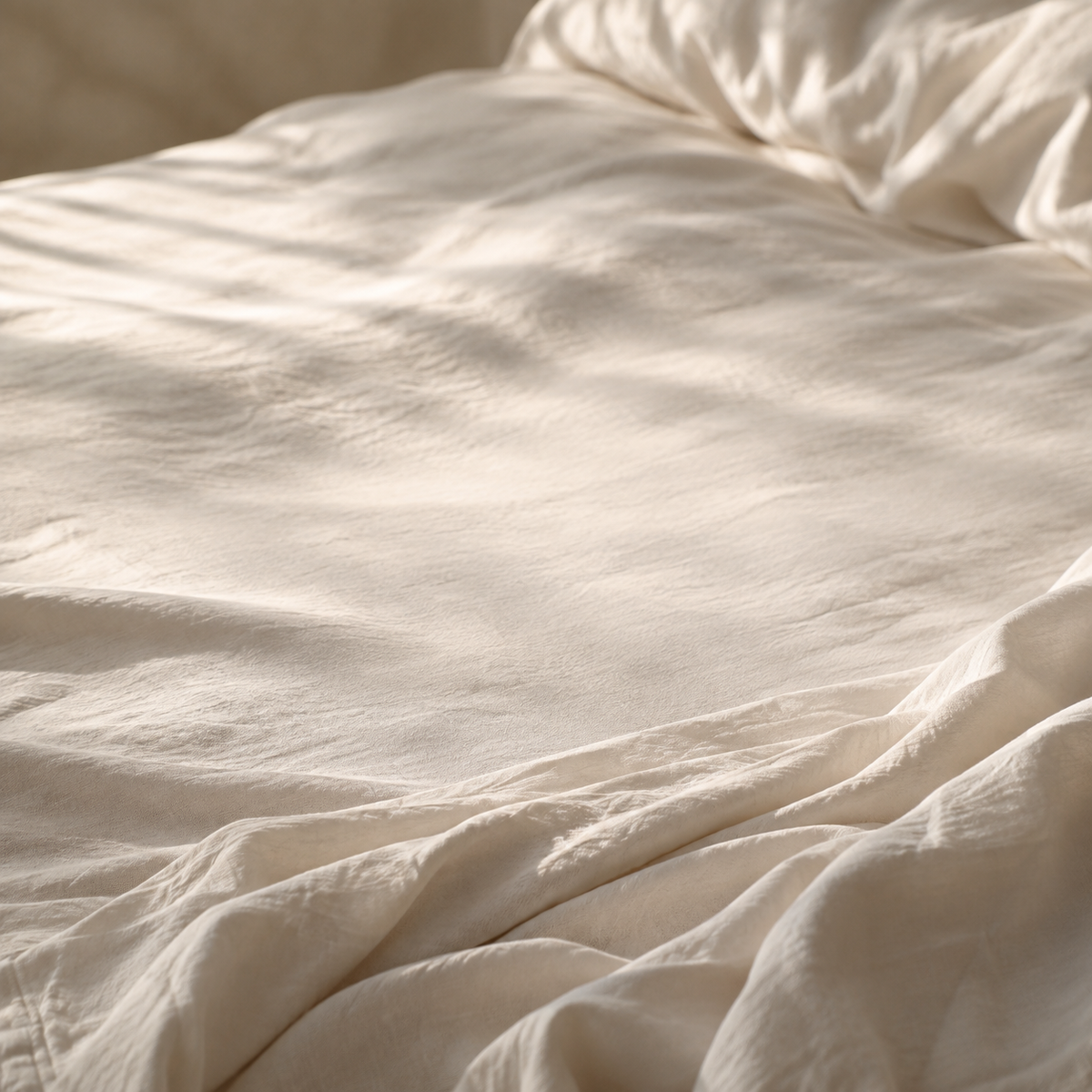 Cream linen bedding in soft morning light